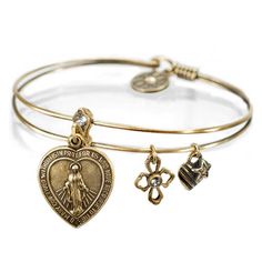 "This bangle bracelet features the Virgin Mary on a heart charm. Slide it open to reveal an inscription of the Lord's Prayer. With each bangle, transmit good vibrations and let the positive energy flow! Our bracelets are made to wear in stacks of your favorite designs. Know someone who could use an uplifting reminder to always have faith? Choice of bronze or silver. \"Our father, who art in Heaven hallowed be thy name. Thy kingdom come. Thy will be done on Earth as it is in Heaven. Give us this Blue Crystal Bracelet, Christian Bracelets, Good Vibrations, Lord's Prayer, Prayer Bracelet, The Lords Prayer, Bangle Bracelets With Charms, Energy Flow, Christian Jewelry