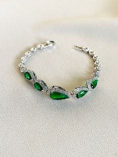 This classic bracelet uses a variety of pear-shaped AAA Cubic Zirconia. This bracelet will make you stand out from the crowd with different sparkles at any angle you stand.  The bracelet length measures 7 inches More Bracelet: https://www.etsy.com/shop/ASparklingOccasion?section_id=18008807&ref=shopsection_leftnav_2 **Orders are sent within 1-3 business days after payment is processed. **All orders will be shipped out with a tracking number for Canada and United State **Custom Made will generall Silver Pear-shaped Bracelets For Anniversary, Silver Pear-shaped Anniversary Bracelets, Pear-shaped Silver Bracelet For Anniversary, Pear-shaped Silver Bracelet For Weddings, Formal Cubic Zirconia Teardrop Bracelets, Green Crystal Bracelet For Wedding, Formal Teardrop Cubic Zirconia Bracelet, Green Crystal Bracelet For Weddings, Green Crystal Wedding Bracelet