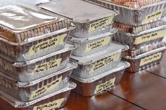 several containers of food sitting on top of a wooden table