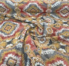 the fabric is very colorful and has an interesting pattern on it's surface,