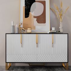 a white and gold sideboard with art on top