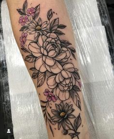 a black and white flower tattoo on the leg