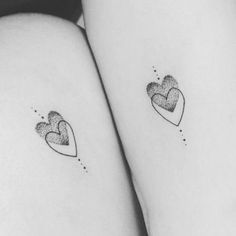 two hearts tattoo on both thighs, one is black and the other is white