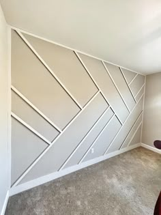 an empty room with white painted walls and carpeted flooring in the foreground