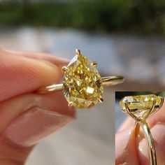 a yellow diamond is being held up to show it's size and shape,