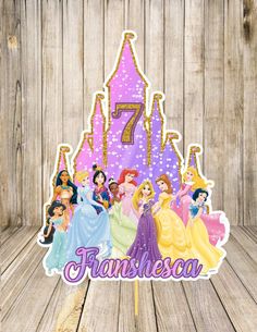 a birthday cake topper with princesses on it