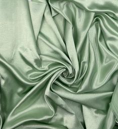 a close up view of a green satin fabric