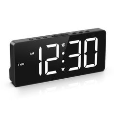 the alarm clock is black and has white numbers