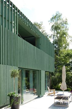 a green building with an open patio area