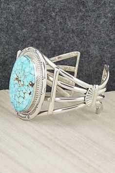 This Kingman turquoise and sterling silver bracelet was made by Navajo silversmith Raymond Delgarito. The inside is signed RD and stamped sterling.Size: 5 1/2" (will fit up to a 6 1/2" wrist)Gap: 1"Width: 1 3/4"Free shipping on all orders! We ship with USPS and always include tracking. All orders ship within a day of payment.Returns are accepted up to 30 days after you receive your order. Just send us a message. Our shop offers cash back or store credit. The item must be returned in new conditio Kandy, Kingman Turquoise, Sterling Silver Bracelet, Cuff Bangles, Native American Jewelry, Fantasy Artwork, Turquoise Sterling Silver, Free Jewelry, Sterling Silver Bracelets