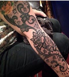 a person sitting down with a tattoo on their arm