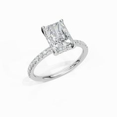 an engagement ring with a princess cut diamond in the center and pave set shoulders