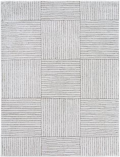 a white rug with squares and lines on the side, in different shades of grey