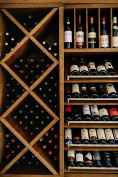 a wooden wine rack filled with lots of bottles