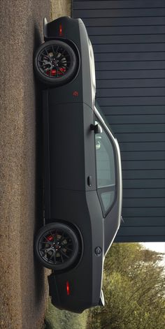 an suv parked next to a wall with the door open