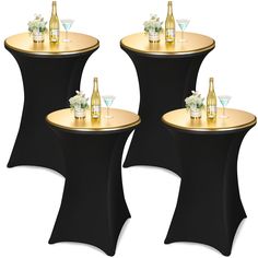 three black and gold tables with champagne bottles