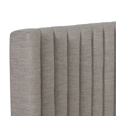 an upholstered headboard with pleated fabric