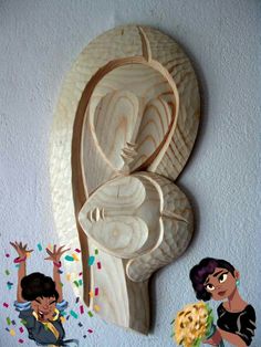 an art piece made out of wood with two women and flowers in front of it