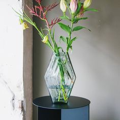 a vase with flowers in it sitting on a table