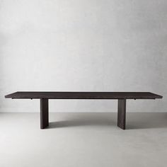 a wooden table sitting on top of a white floor