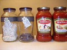 three jars filled with food sitting on top of a table