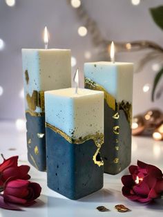 three candles sitting next to each other on a table