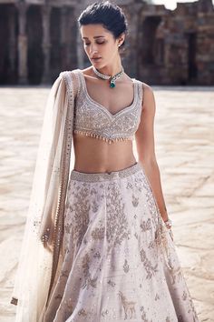 Introducing the tuscan beige lehenga, a masterpiece crafted from luxurious raw silk, exuding timeless elegance and sophistication. This exquisite ensemble showcases impeccable anmol dori work, meticulously depicting the breathtaking landscape of masai mara in an artful manner. Handwork highlighted with pearls, mirrors, and sequins adds a touch of opulence and charm to the intricate embroidery. Complemented by the iconic matsya v-wing belt, the tuscan beige lehenga captures the essence of traditi Matsya Lehenga, Handwork Lehenga, Beige Lehenga, Latest Bridal Lehenga Designs, Tuscan Landscape, Dori Work, Bridal Lehenga Designs, Latest Bridal Lehenga, Desi Outfits