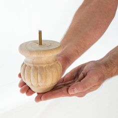 a person holding a wooden object in their hand