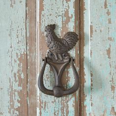 an old style door handle with a rooster on it's side and the handles are made out of cast iron