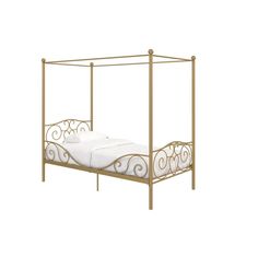 a gold metal bed frame with white sheets