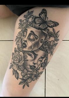 a woman's thigh with flowers and butterflies on her leg, in black and white