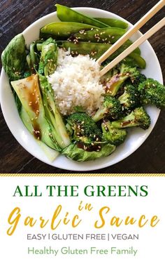 a white plate topped with broccoli and rice next to chopsticks on top of a wooden table