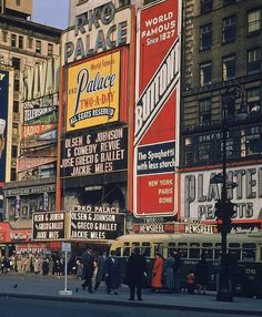 a city street filled with tall buildings and lots of signs on the side of it