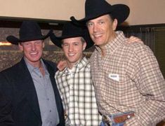 three men in cowboy hats posing for a photo