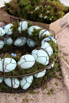 a wreath made out of eggs sitting on top of a table next to a cardboard box