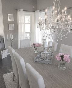 a dining room table with chairs and chandelier in the center, on an instagram page