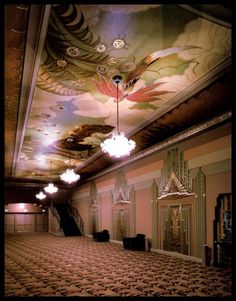 an empty ballroom with chandeliers and paintings on the ceiling