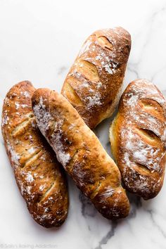 four sausages are sitting on a piece of paper