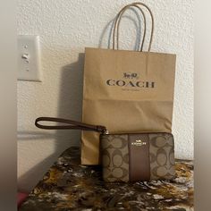 Authentic Coach Wristlet!! Excellent Flawless Condition. Includes Shopping Bag! Coach Brown Bag For Gift, Coach Brown Bag As Gift, Coach Brown Bag As A Gift, Brown Pouch Wristlet For On-the-go, Brown Wristlet With Removable Pouch As Gift, Chic Brown Wristlet For Everyday Use, Brown Rectangular Wristlet For On-the-go, Brown Wristlet With Removable Pouch, Casual Brown Wristlet With Wrist Strap