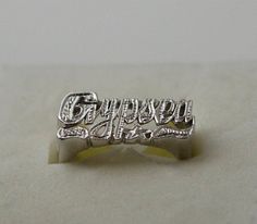 Cursive style name ring in silver decorated with hand beading is a perfect statement ring for you. Use this modern name ring also as a knuckle ring (go one size smaller than your regular finger size) or as a Pinky ring. You could also do other word phrases with single ring or a double 1. Team name. 2. Group name. 3. Sports team name. 4. MEN NAME and many more....( contact me for more info) 5. A.K.A names. All my beautiful name rings and other pieces are proudly made in USA! **COLOR** gold rhodiu Personalized Symbolic Silver Jewelry, Symbolic Silver Jewelry With Name Detail, Silver Open Ring With Custom Name, Symbolic Silver Jewelry With Name, Silver Promise Ring With Name, Silver Engraved Open Ring With Name, Silver Open Ring With Name Detail, Custom Name Silver Rings For Promise, Silver Initial Ring With Name For Anniversary