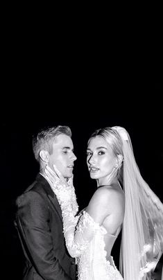 the bride and groom are posing for a black and white photo