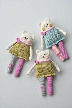 three crocheted teddy bears are laying next to each other on a gray surface