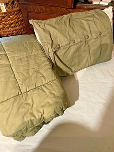 two pillows sitting on top of a bed