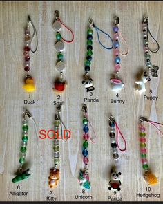 several different types of bead necklaces are shown on a wooden surface with the words sold written below them