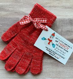 a pair of red gloves with a tag attached to it