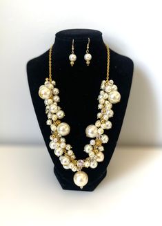 "Chic cluster ivory pearl necklace with matching earrings. This bib cluster necklace is made with dangle cream glass pearls different size on a gold  tone chain with some sparkly crystal, gold beads and finished with lobster-claw clasp.  Coordinate this clustered necklace with any ensemble from business casual to everyday wear. Well balanced pearl to fit any style.  Approximate length:17+3\" adjustable chain (43+7 cm) Perfect necklace for bridesmaids!" Gold Pearl Drop Necklace In Costume Jewelry Style, Gold Pearl Bridal Necklace In Costume Style, Gold Pearl Jewelry Sets With Pearl Drop, Gold Costume Jewelry Pearl Necklace For Wedding, Gold Dangle Pearl Necklace For Party, Cream Pearl Jewelry For Party, Party Jewelry With Cream Pearls, Gold Pearl Bridal Necklace For Party, Cream Dangle Jewelry For Party