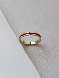 This narrow ring with a stripe is made of gold with hot red enamel. Great piece of statement jewelry and minimalism.  Please note this listing represents only 1 ring, if you want to buy a pair, please buy it twice providing size for each ring separately. Details:  Width: 3 mm Thickness: 1.2 mm Materials: yellow gold 14kt, hot vitreous enamel The surface has structure that does not cling or scratch. Please read my shipping and policies tab for shipping info.  All items are packaged in moisture re Basic Ring, Ring Everyday, Wedding Red, Ring Elegant, Vitreous Enamel, Red Line, Minimalist Ring, Enamel Ring, Solid Gold Rings