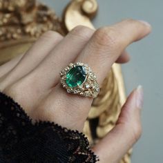 Read about our payment plans before proceeding. Our "Tulip Majesty Emerald Bloom Ring." A mesmerizing oval emerald, reminiscent of a lush oasis, is embraced by delicate tulip petals, accented by sparkling diamonds. Experience the essence of spring's romance captured in this timeless treasure. Perfect for those who seek nature's elegance and enduring beauty. Crafted by skilled hands, this ring is available in your choice of 14K and 18K yellow gold, rose gold, and white gold. All emeralds are natural so it can differ from the image. All orders come in our Tippy Taste ring box. This ring is handmade and designed in NYC. 14K or 18K solid gold Natural 10*8mm oval emerald. Approx. 2.5ct Natural diamonds. SI clarity, GH color, 0.08ct total carat weight ** Tippy Taste Heirloom Collection is made t Luxury Oval Emerald Heirloom Ring, Luxury Antique Oval Emerald Ring, Luxury Oval Emerald Birthstone Ring, Exquisite Oval Green Emerald Ring, Exquisite Green Oval Emerald Ring, Elegant Marquise Emerald Ring, Oval Tsavorite Wedding Ring, Exquisite Oval Emerald Ring In Yellow Gold, Exquisite Green Emerald Ring In 14k Gold