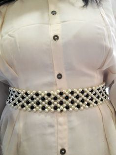 This belt is handcrafted with precision and features lustrous cream and black pearls meticulously arranged. Easily Adjustable to any waist size. Best goes with Knee Length Dresses, Gowns, Sarees. Can be worn with any colour of dress. Can be cutomised in any colour. Pearl Belts, Pearl Belt Diy, Pearl Belt, Pearl Waist Belt, Waist Belt Pearl, Silver Bridal Belt With Pearl Embroidery, Suspender Belt, Knee Length Dresses, Black Pearl