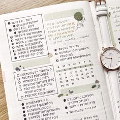 a close up of a planner with a watch on it's wrist and an open notebook